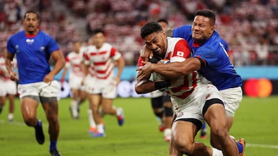 Timothy Lafaele of Japan is tackled by Alapati Leiua of Samoa. Getty