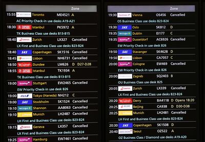 Cancelled flights on a departures display board at Heathrow Airport in London. EPA
