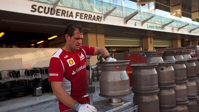 A Ferrari pit crew member prepares wheels for the weekend's race. Christopher Pike / The National