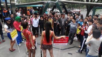 In Shenzhen, a troupe of young artists dressed as mistresses and as a corrupt official to speak out against corruption and the decadent behaviour of officials. Imaginechina via AP Images