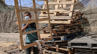 Palestinian workers recycle used wood at a workshop at Rafah in the southern Gaza Strip. AFP