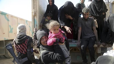 Iraqi army soldiers helping displaced civilians as they flee their homes due to fighting between Iraqi security forces and ISIL militants, on the western side of Mosul, Iraq, on February 26. 2017. Khalid Mohammed/AP Photo