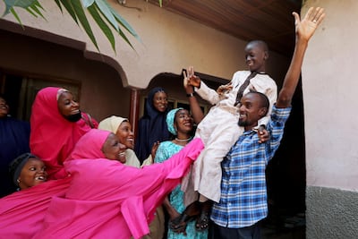Mohammed Bello, one of the Nigerian students recently rescued from kidnappers, is carried by his father as relatives celebrate his return. Reuters