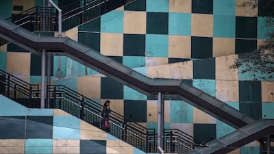 A woman walks down a set of stairs from a housing estate in Hong Kong. AFP