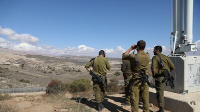 Israeli forces look out over the border fence between the Israeli-occupied side of the Golan Heights and Syria on November 4, 2017. Ammar Awad / Reuters