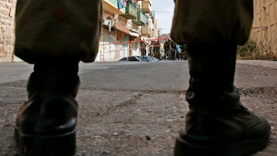 Members of the Israeli security forces surround the body of a Palestinian in the occupied West Bank town of Hebron on October 22, 2018. AFP