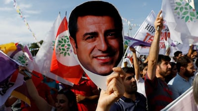 A supporter of the pro-Kurdish Peoples' Democratic Party holds a mask of their jailed former leader and presidential candidate Selahattin Demirtas during a rally in Ankara, Turkey. Reuters