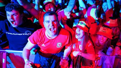 Wales supporters at a fan zone in Cardiff watching their match against the USA, which ended 1-1 thanks to a late Gareth Bale equaliser from the penalty spot. PA