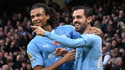 Bernardo Silva celebrates with Nathan Ake after scoring Manchester City's second goal in their 6-1 Premier League win over Bournemouth at the Etihad Stadium on November 4, 2023. AFP
