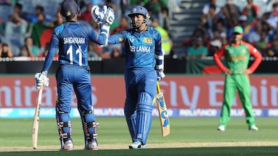 Sri Lanka's Tillakaratne Dilshan celebrates with Kumar Sangakkara during their win against Bangladesh at the 2015 Cricket World Cup on Thursday in Melbourne. Mal Fairclough / AFP / February 26, 2015