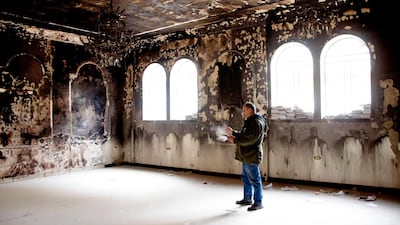 Syrian Nabil Al Aash inspects the Greek Orthodox Church of Saint George in Arbin. AFP