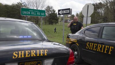 Local law enforcement officials at one of the locations of multiple shootings in the US state of Ohio on April 22, 2016. John Minchillo / AP Photo