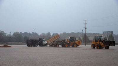 Workers scramble to build a temporary dam to stop rising flood waters from Hurricane Florence in Lumberton, North Carolina. AFP