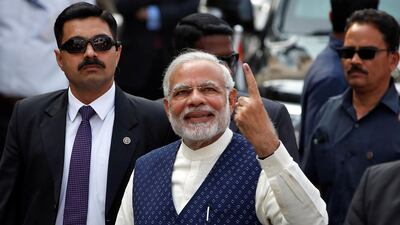 India's prime minister Narendra Modi shows his ink-marked finger after casting his vote at a polling station in Ahmedabad during the last phase of Gujarat state assembly election on December 14, 2017. Amit Dave / Reuters