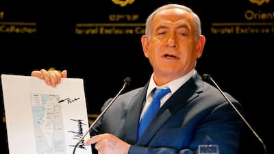 Israeli Prime Minister Benjamin Netanyahu displays a US State Department map of Israel showing the annexed Golan Heights as part of its territory, at a hotel in Jerusalem on May 30, 2019. AFP