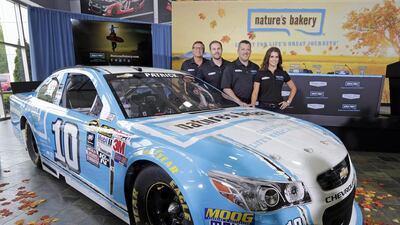 Danica Patrick, right, says that the sponsor change of GoDaddy's neon green and black to Nature's Bakery blue-and-white will do wonders for her complexion. Chuck Burton / AP Photo