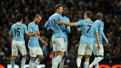 Manchester City's players celebrate with seven players getting their names on the scoring chart. Paul Ellis / AFP