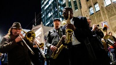 Musicians in a brass band play music along Bush Street during a demonstration in part of a national impeachment rally, at the Federal Building in San Francisco, California. AFP