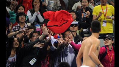 Getting shirty: Serbian Novak Djokovic throws his top to fans after beating Florian Mayer of Germany in the semi-final of the China Open in Beijing. E Jones / AFP