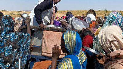 People gather to receive food at a camp in Tawila, Sudan, where they fled after the fall of the city of El Fasher. AP Photo