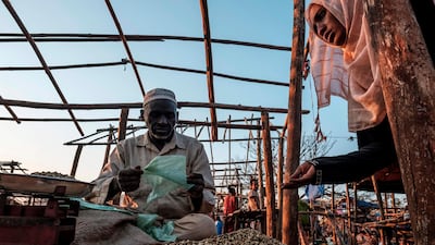 A woman inspects green coffee beans at a stall in the local market in the city of Asosa, Ethiopia. With a new app, coffee drinkers can know more about what's in their cup and how it got there. AFP