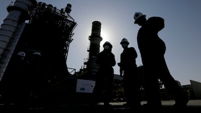 Saudi Aramco engineers near a gas turbine generator at Khurais oil field. The kingdom will cut oil production by 500,000 barrels per day from May until the end of 2023. AP