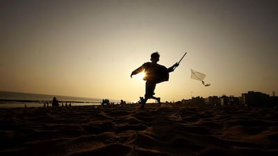 An Indian boy runs as he tries to fly a kite on the Bay of Bengal coast at Puri, Orissa state. Biswaranjan Rout / AP Photo