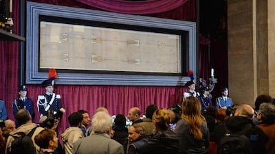 People look at the Holy Shroud of Turin during a press preview at the Cathedral of Turin, in Turin, Italy, on April 18, 2015. Alessandro Di Marco/EPA