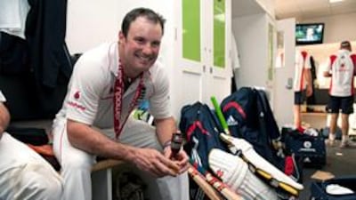 Andrew Strauss celebrates in the England changing room with the Ashes urn following the 197-run win at the Oval.