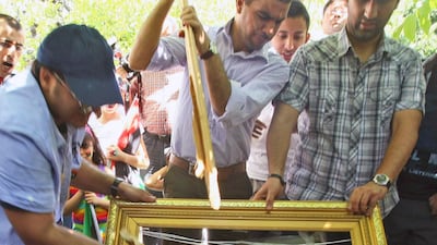 Libyans living in Turkey destroy a poster of Libyan leader Moammar Gadhafi outside the Libyan embassy in Ankara, Turkey, Monday, Aug. 22, 2011. Turkey's foreign minister Ahmet Davutoglu, who met with Libyan rebel leaders in Benghazi Tuesday, Aug 23, 2011, says in that NATO operations will continue until "security in Libya is fully restored." Davutoglu also said Tuesday all frozen Libyan assets should be returned "to the service of the Libyan people," adding the country was in urgent need of "financial resources."(AP Photo) *** Local Caption *** Turkey Libya protest.JPEG-06098.jpg