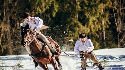 Polish villagers from the Tatra Mountains compete during a horse-drawn skiing event, dressed in traditional costumes. AFP / LUKASZ NODZYNSKI