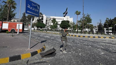 A member of the Syrian security forces near the army headquarters and Defence Ministry. AFP