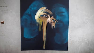 Palestinian artist Ali al-Jabali, displays his a painting during his an exhibition ''Dreamers among the rubble'' on the Italy tower, which was destroyed in the recent Israeli war on Gaza Strip. Courtesy Fady Hanona