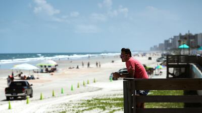 Tom Crane looks out over the beach as the threat of Hurricane Dorian looms, on August 31, 2019 in Daytona Beach, Florida. Dorian could be a Category 4 storm as it approaches the state and possibly making landfall as early as Monday somewhere along the east coast. Mark Wilson/Getty Images/AFP