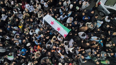 The flag-draped casket of Syrian activist Mazen Al-Hamad during his funeral in Damascus. Getty Images