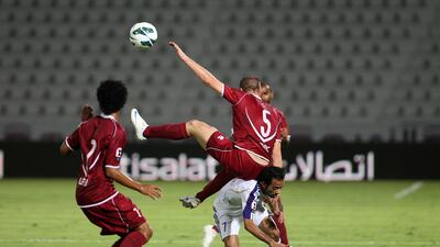 Al Wahday's Srdan Andric and Ali Al Wehaibi of Al Ain tussle for the ball in their 0-0 Etisalat Cup tie. Pawan Singh / The National