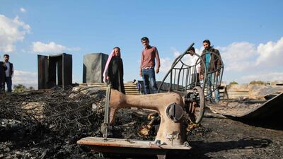 The remains of a home where several Pakistani farmers were killed in a fire in the town of Shuna. AFP