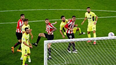 Athletic Bilbao's Inigo Martinez scores their second goal against Atletico Madrid. Reuters