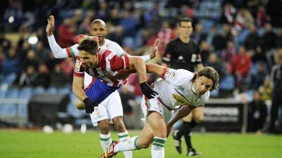 Atletico Madrid midfielder Juanfran, left, vies with Granada midfielder Manuel Iturra during their La Liga match on Wednesday. Pedro Armestre / AFP / March 26, 2014