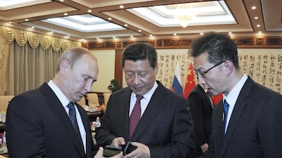 Russia's president Vladimir Putin presents a Russian-produced Yotaphone 2 to Chinese president Xi Jinping at their meeting in Beijing on November 9, 2014. Mikhail Klimentyev / RIA Novosti / Kremlin / Reuters