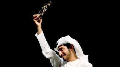 Hasan Morad Al Beloushi, recipient of a young media leader award, accepts his accolade during the Abu Dhabi Festival awards ceremony last night.