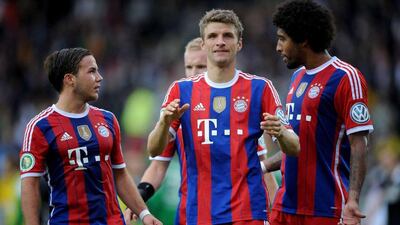 Thomas Muller, with teammates Mario Gotze, left, and Dante, right, and Bayern Munich are expected to claim their third successive Bundesliga title in 2014/15, Jonas Guettler /AFP / DPA