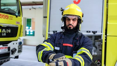 Firefighter Juma Saeed Al Nuaimi suits up at Saadiyat island's civil defence station. All photos by Victor Besa / The National