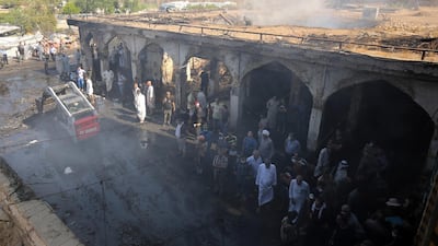 Iraqis look at the damage at aftermath scene of a mortar and bombing attack on the Sayyid Mohammed shrine in the Balad area, located 70km (around 45 miles) north of Baghdad, on July 8, 2016. AFP