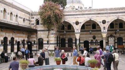 Tourists walk around Al Azem Palace, which houses the museum of arts and popular traditions in the Old City of Damascus, Syria.