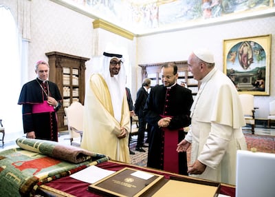 President Sheikh Mohamed, at the time Crown Prince of Abu Dhabi and Deputy Supreme Commander of the Armed Forces, gives Pope Francis the Tolerance Carpet in 2016. The rug was handwoven by Afghan women as part of the Fatima bint Mohamed Initiative. Photo: FBMI