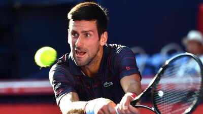 Novak Djokovic hits a return against David Goffin in their men's singles semi-final match at the Japan Open. AFP