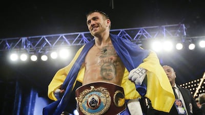 Vasyl Lomachenko, of Ukraine, poses for photographs with the WBO junior lightweight belt after winning it on Saturday. Frank Franklin II / AP Photo / June 11, 2016