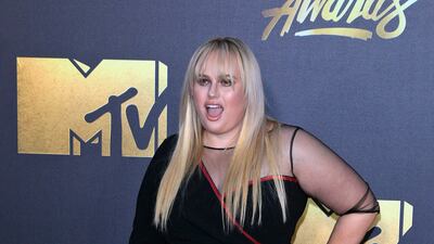 Rebel Wilson, in a black dress with one sheer sleeve, arrives for the MTV Movie Awards in Burbank, California on April 9, 2016. EPA