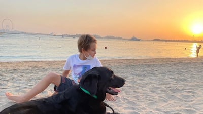 Bill the dog with Noah, nine. The Labrador either escaped or was stolen from the Goberts' garden in Jumeirah Village Triangle on April 7. All photos: Cecile Gobert